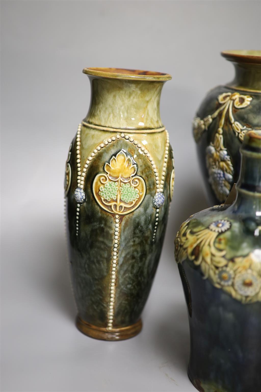 A pair of Royal Doulton vases, a similar larger vase and a small flagon